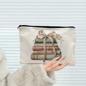 Canvas makeup bag featuring an elegant vintage watercolor book stack and bow print.
