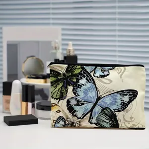 Close-up detail of a canvas cosmetic bag featuring a stunning blue and green butterfly print.