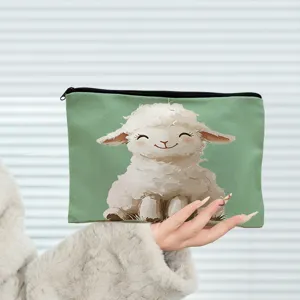 Close-up detail shot of a green cosmetic bag featuring a cute fluffy lamb print design.