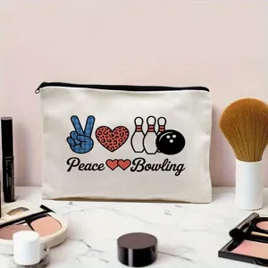 Canvas makeup pouch detail showing bowling and peace print on white fabric surface.