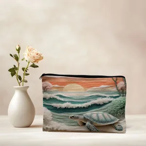 Detailed view of portable canvas makeup bag with scenic ocean sea turtle design.