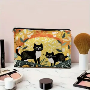 Detail view of the black cat cosmetic bag featuring autumn foliage print and secure zip.