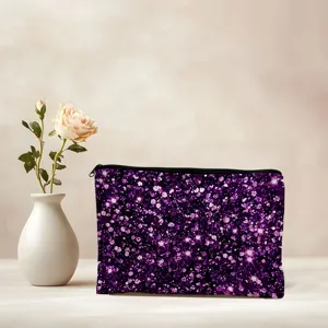 Purple glitter cosmetic bag detail view, stylish sparkly makeup pouch on neutral table.