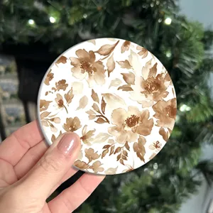 Close-up of a retro brown watercolor floral coaster, showing texture and clear pattern details.