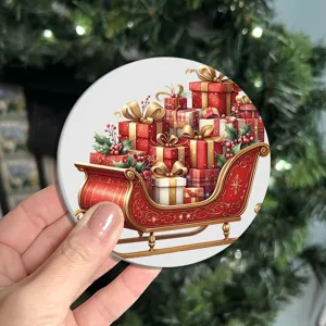 Christmas ceramic drink coaster with festive red sleigh and gift box pattern for coffee cups.