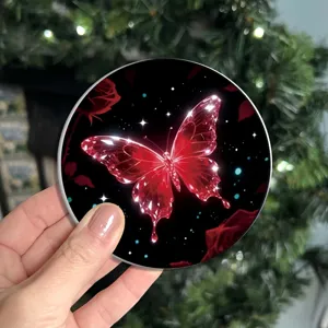 Round silicone coaster detail showing glowing red crystal butterfly and rose pattern.