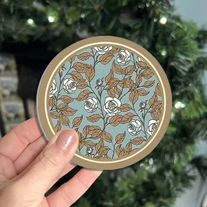 Round silicone drink coaster with vintage blue and brown rose floral pattern design.