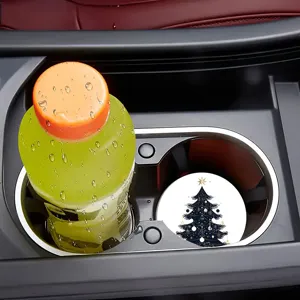 Detail shot of a car cup coaster with a festive dark blue Christmas tree pattern in a car console.