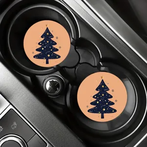 Detailed close-up view of festive Christmas tree silicone car coasters in cup holders.