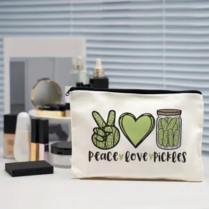 Canvas makeup bag detail featuring creative pickle print and durable zipper closure pouch.