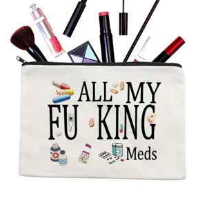 Close-up detail of the canvas zipper makeup pouch featuring funny slogan and pill print.