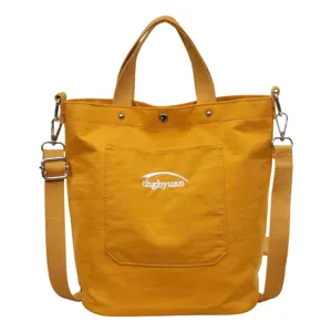 Sac à bandoulière jaune en toile, grand cabas avec poche avant et broderie pour femmes.