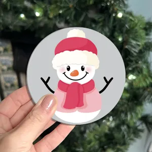 Cute cartoon car coaster detail showing the adorable snowman pattern and fine leather texture.