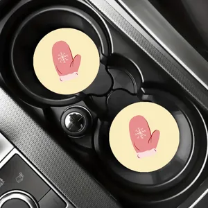 Detailed view of cute winter pink mitten and snowflake design car cup coasters in holder.