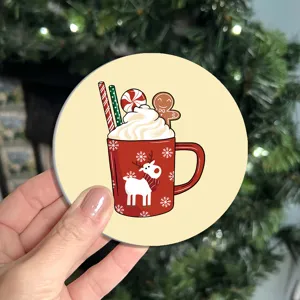 Christmas themed round coaster close-up showing festive reindeer mug illustration, table mat decor