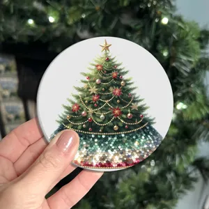 Close up of a round Christmas tree patterned coaster with festive sequin design detail.