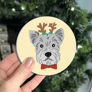 Cute cartoon dog car coaster with reindeer antlers and red bow tie, perfect festive interior decor.