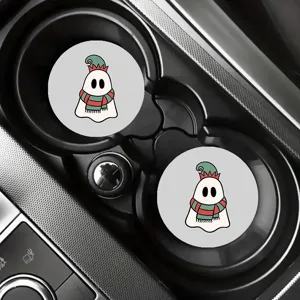 Close-up detail view of cute cartoon ghost car cup coasters, anti-slip auto interior decor mats.