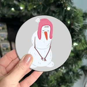 Cartoon sad snowman round PVC coaster detail showing cute illustration design for table decor