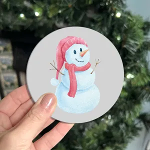 Detailed close-up of a festive watercolor snowman car coaster with a cute red hat and scarf.