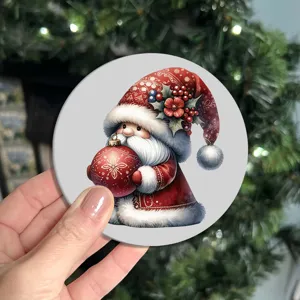 Close-up of a round Christmas gnome silicone coaster featuring a festive red holiday hat.