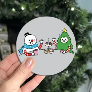Detail view of the cute Christmas cartoon coaster showing the adorable snowman and tree design.