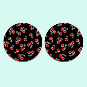 Detailed view of round car cup coasters featuring cute red cherry pattern on black base.