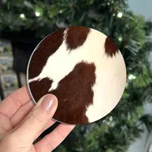 Round car coaster with classic brown and white cow print design, anti-slip silicone mat for auto.