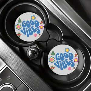 Detailed shot of Christmas car cup coasters in a cup holder, featuring festive cartoon print.