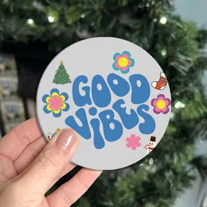 Close-up detail shot of the cute retro Christmas car coaster with good vibes and festive art.