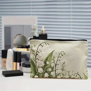 Close-up detail of a portable polyester cosmetic bag featuring elegant lily floral print.