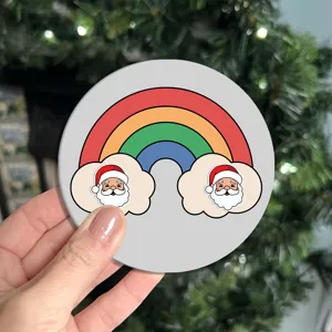 Close-up detail of festive Christmas car cup coaster with cute rainbow and Santa cartoon.