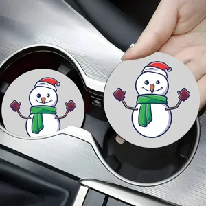 Close-up detail shot of cute Christmas snowman car cup coaster displayed in center console.