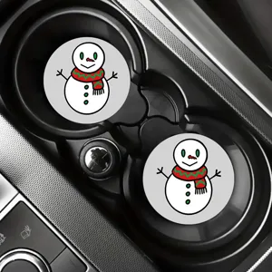 Close-up detail showing Christmas snowman car cup coasters placed neatly inside the vehicle holder.