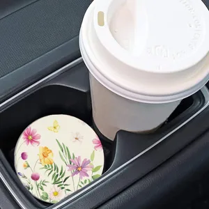 Detail shot of a round floral car cup coaster, non-slip silicone mat for vehicle interior use.