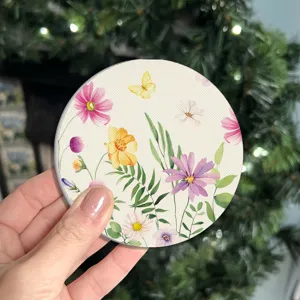 Detail view of round silicone car cup coaster with watercolor floral butterfly print.
