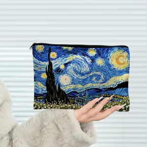 Close up of cosmetic pouch featuring starry night art print, zipper closure detail.