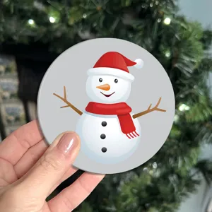 Detailed view of a cute cartoon snowman round car coaster, perfect for festive cup decor.