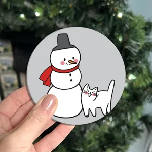 Close-up detail of the cute cartoon snowman and cat print car cup coaster, festive decor.
