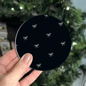 Black silicone coaster with white bowknot pattern, flexible table mat for home decoration use