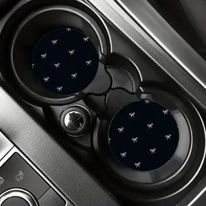 Black silicone car cup holder coasters with cute white bow pattern, anti-slip auto cup mats.