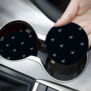 Black silicone car coaster featuring a cute white bow pattern, practical cup holder insert.