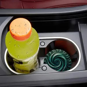 Creative round car cup coaster with abstract green spiral pattern for modern decor.