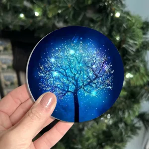 Close-up detail of the glowing blue tree pattern car coaster, non-slip silicone cup mat.