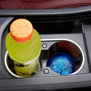 Silicone car coaster detail showcasing non-slip cup holder mat with glowing tree pattern inside car.