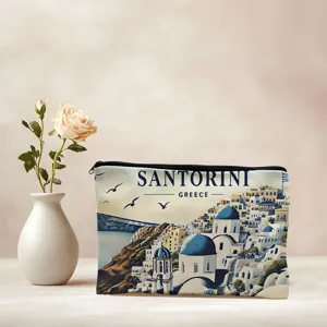 Detailed view of a portable cosmetic bag featuring a scenic Santorini Greece print design.