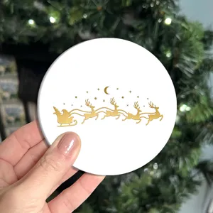 Christmas gold silhouette printed white round cup coaster detail view, holiday home decor.
