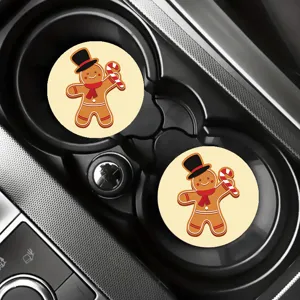 Close-up detail of cute Christmas gingerbread man car coasters placed inside vehicle cup holder.