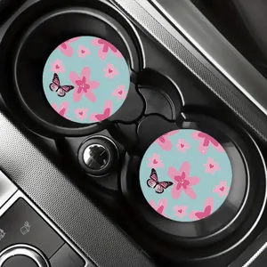 Close up view of cute floral and butterfly pattern car cup coasters placed in vehicle holder.
