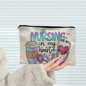Canvas cosmetic bag detail, cute nurse theme print with heart and stethoscope, secure zipper.